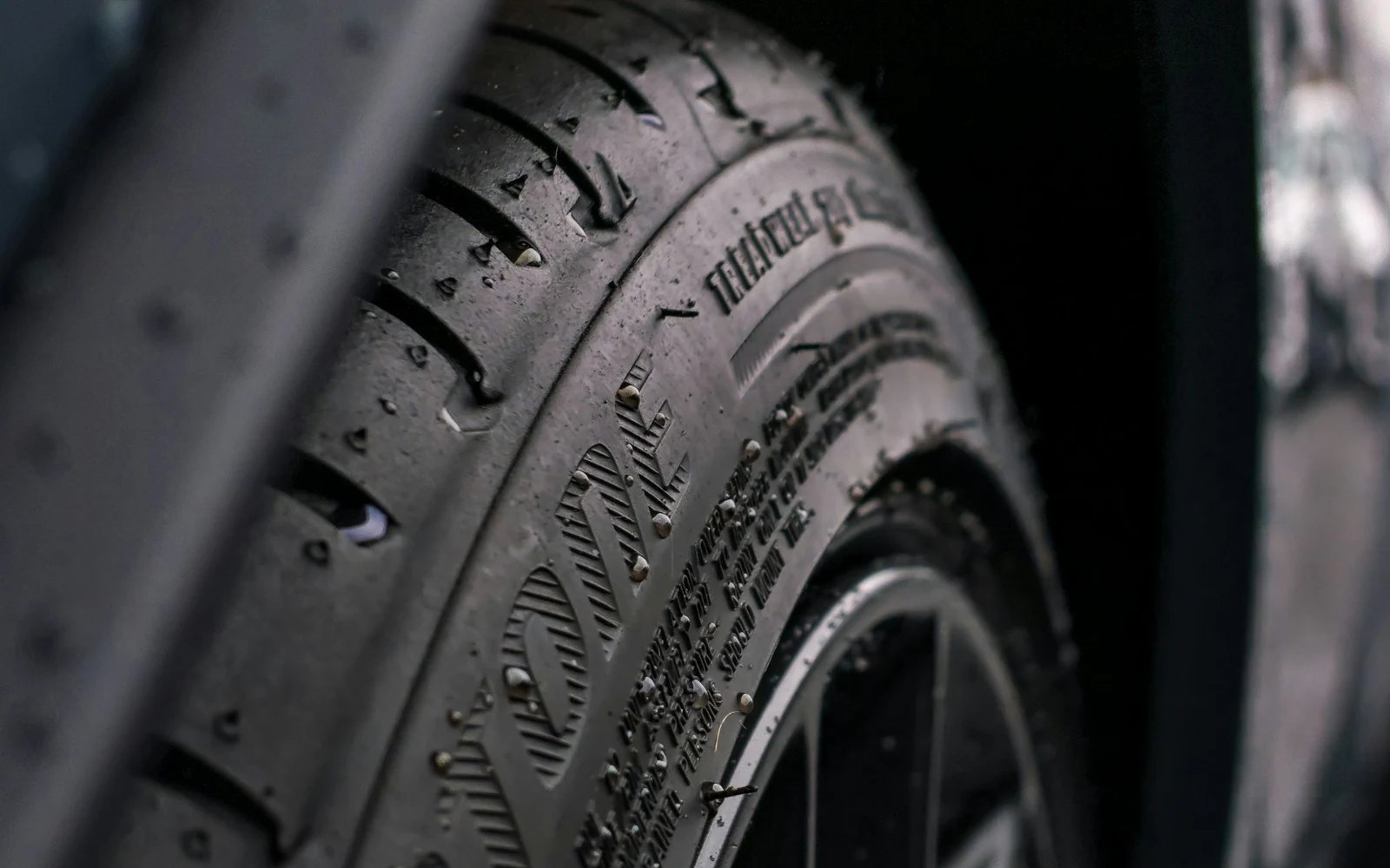 Close up of a wet tyre tread and sidewall on a mounted wheel